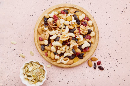Assortment of nuts and raisins in wooden tray flat lay. Healthy food, dessert.の写真素材
