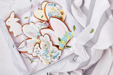 Gift box with Easter decorated glazed cookies. Spring cozy aesthetic table