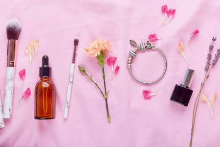 Aesthetic female make up set. Dropper bottle, brushes, jewelry and lavender flat lay.の写真素材
