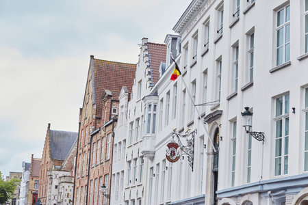 Traditional Belgian Architecture in the Heart of Bruges with flags.の写真素材