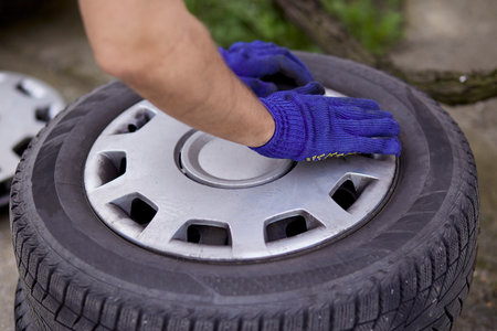 Changing of tires on the car with tools close up. Seasonal work. Safety concept.