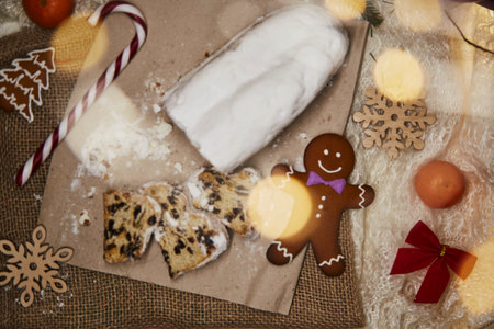 Christmas stollen - traditional holidays bread, gingerbread cookies, candy cone stick, tangerines...
