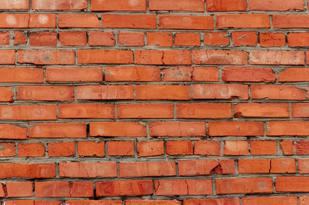 Closeup of masonry red brick, with cement fragmentsの写真素材
