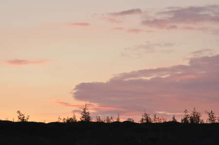 During sunset, the clouds have taken the form of the head of a dragon with protruding tongueの写真素材
