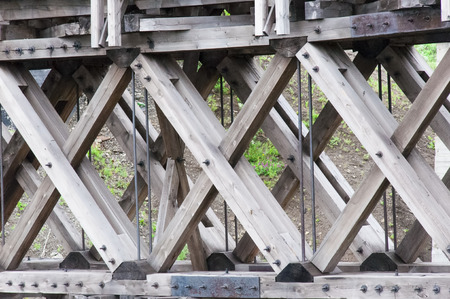 view up close the construction of the bridge made of wood with large beamsの写真素材