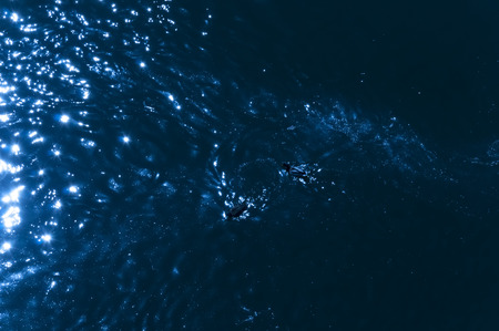 Reflection of light from the moon in the shining blue waterの写真素材