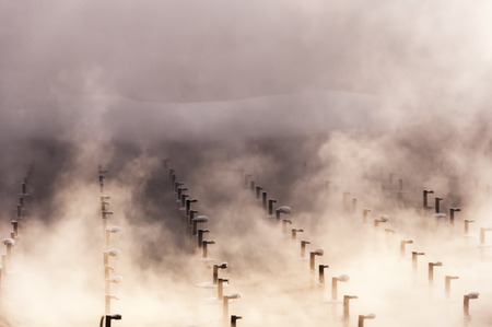 cooling of water on production, the rising steam over a reservoirの写真素材