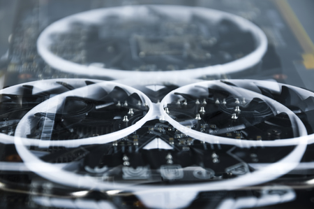 Close - up of a video card with two fans, computer equipment. Multi-exposure frame.