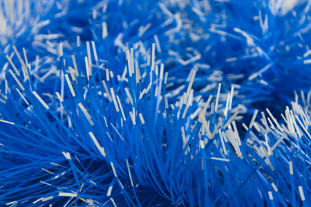 Close-up of blue tinsel with white tips, background.の写真素材