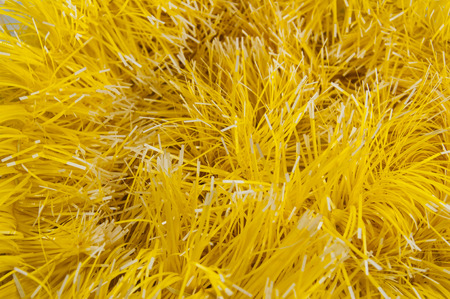 Close-up of tinsel yellow with white, tips, backgroundの写真素材