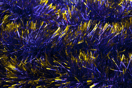 Close-up of blue tinsel with yellow, tips, backgroundの写真素材