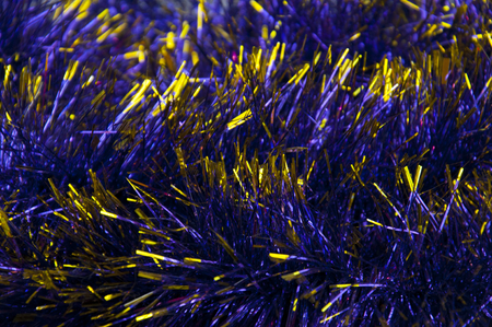 Close-up of blue tinsel with yellow, tips, backgroundの写真素材