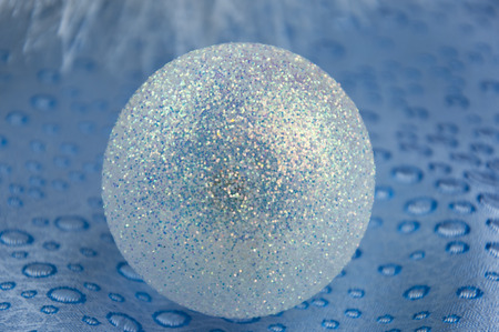Christmas ball with sparkles on a blue background fabricの写真素材