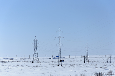 Landscape. Supports power lines in the white snow. Against the blue sky.の写真素材