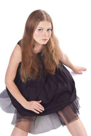The long-haired girl sitting on the floor isolated on white backgroundの写真素材
