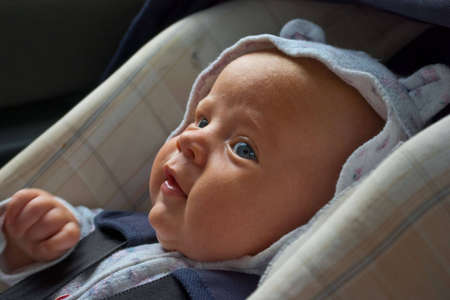 happy little boy in car seatの写真素材