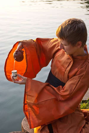 tea ceremony master serving tea near the waterの写真素材