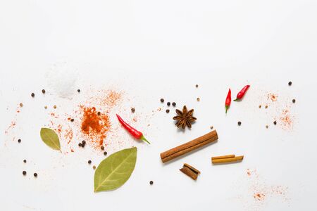 set of assorted colorful spices on a white background, flat lay, top view, with copy spaceの写真素材