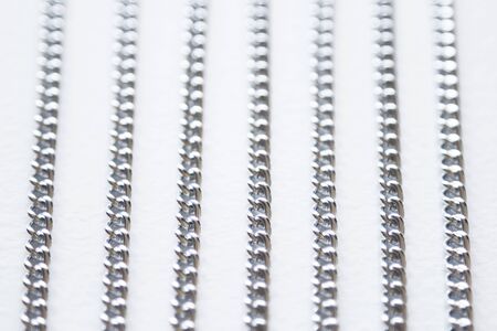 Long silver colored chain isolated on white