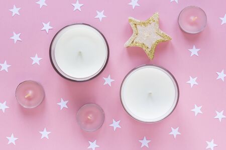 Flat lay arrangement of candles for mock up design, table top view image of decoration pastel pink backgroundの写真素材
