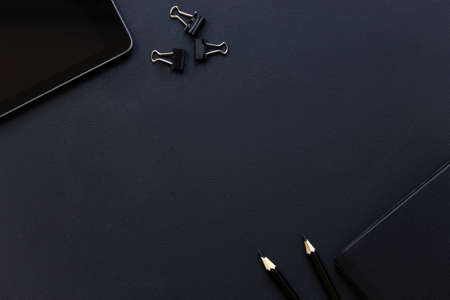 Top view flat lay of business working place. Empty workspace on table. Black minimalism.