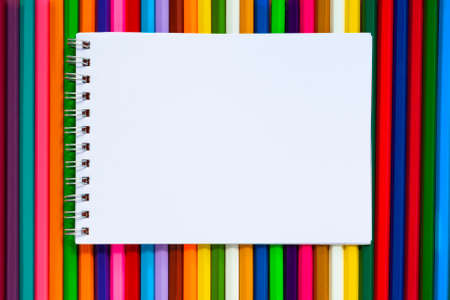Paper note on colorful multicolor pencils flat lay, top view, back to school, copy space, mockup.