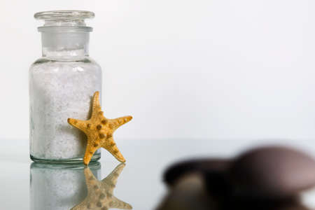 Bath sea salt in glass bottle on white background. SPA product. Home careの写真素材