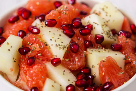 Fresh fruit salad in bowl. Concept healthy food, diet, vegan. Close up.の写真素材