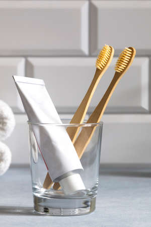 Bamboo toothbrushes and toothpaste in glass. Zero waste concept. Eco-friendly accessories.の写真素材
