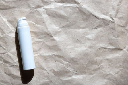 Skin care cosmetic bottle cream on craft paper background copy space.の写真素材