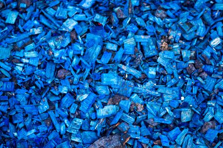 Blue wood chips closeup. Decorative texture of wood chips. Natural material pattern of blue wooden...