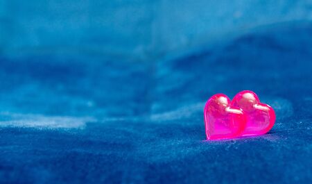 Pink glass heart, on a dark blue background. The concept of Valentine's Day, background.の写真素材