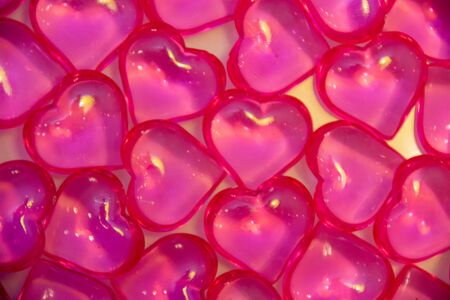 Background of pink, glass hearts on a white background. The concept of Valentine's Day, background, texture.の写真素材