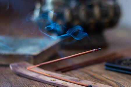 Incense sticks and smoke from burning incense. A wonderful smoke. Blurred background.の写真素材
