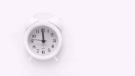 white alarm Clock on a white background. Place to copy. Minimal concept.