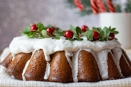 Christmas Stollen: a festive cake decorated with cranberries and twigs. Christmas decor on the...