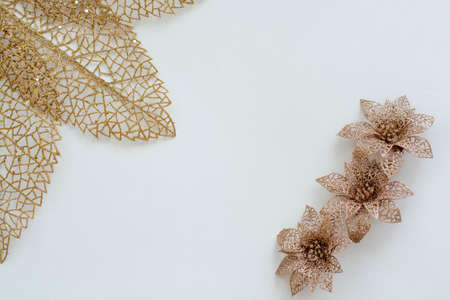 Golden leaves, flowers, on a pink background, postcard, layout for design. Christmas decorations.