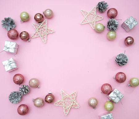 Christmas composition. Christmas decorations on a pastel pink background. Balls, cones, stars. 2021. Flat stacking, top view, copy spaceの写真素材