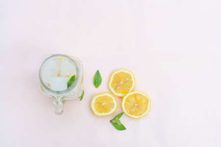 Lemonade with ice in a fashionable glass with a strawの写真素材