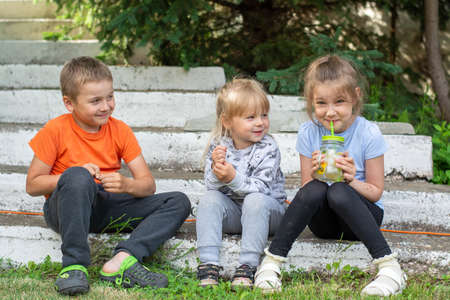 Little children with natural lemonade in park