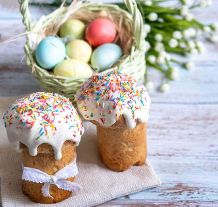 Easter cake, with a porcelain rabbit in the background, on a white table. selective focus. Copy the place for the textの写真素材