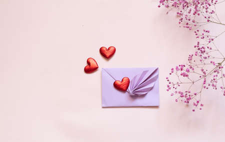 An envelope for Valentine's day made with your own hands, on a pink background with flowers and...