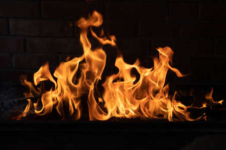 The texture of the fire is close, red and yellow, thermal energy at the fuel supply point at night, lights on a black background.の写真素材