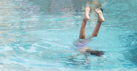 Excited funny little girl jumping to the swimming pool. Happy summer vacation