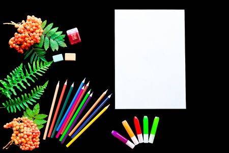 school supplies on a black background with a white sheetの写真素材