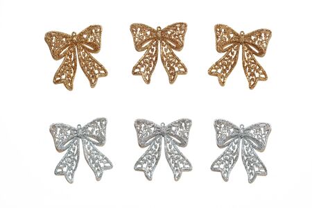 Set of 3 golden bows and 3 silver bows on an isolated background. For a festive mood and gifts. View from above.の写真素材