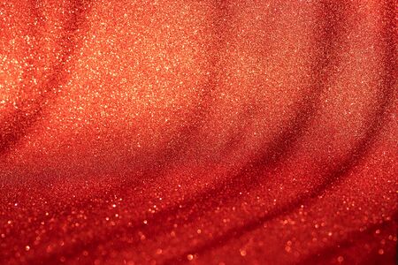 Red bokeh holiday textured glitter background blurred from above.の写真素材