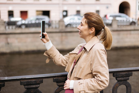 Close-up portrait of female tourist, taking photos in the city on a walk