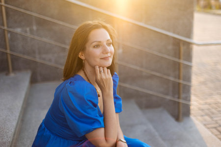 Young woman in the rays of the setting sun, soft light, close up
