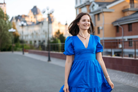 Young attractive girl on a walk in a modern city, copy spaceの写真素材